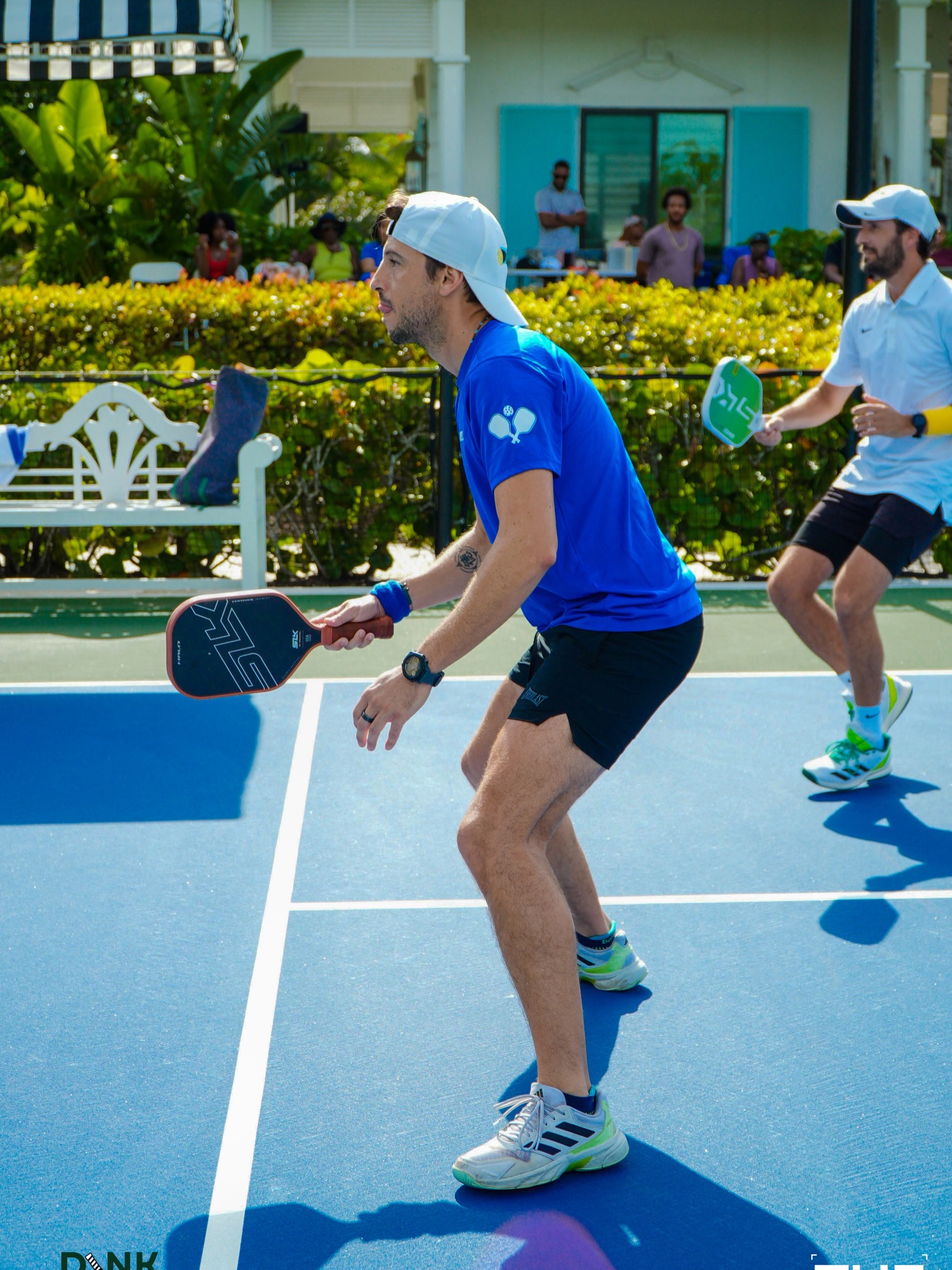 A member practicing a soft dink during a club session on the blue courts
